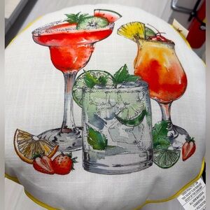 Tommy Bahama 18”circular indoor/outdoor “cocktail” pillow w/yellow piping.